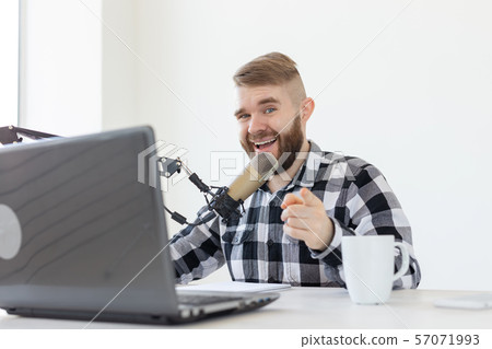 blogger, streamer and broadcasting concept - young man DJ working on the radio. 57071993