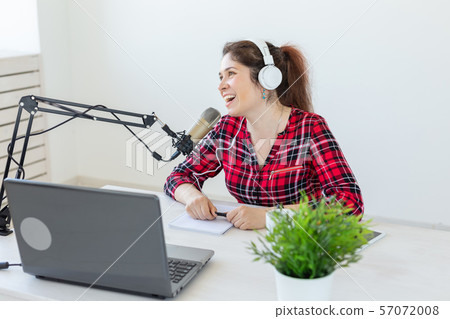 Radio host, blogging, broadcasting concept - young woman working on the radio Radio host, blogging, broadcasting concept - young woman working on the radio 57072008