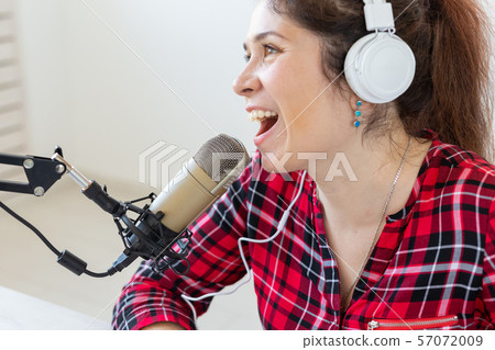 Radio, blogging, podcasting concept - close-up woman presenter on the radio Radio, blogging, podcasting concept - close-up woman presenter on the radio 57072009