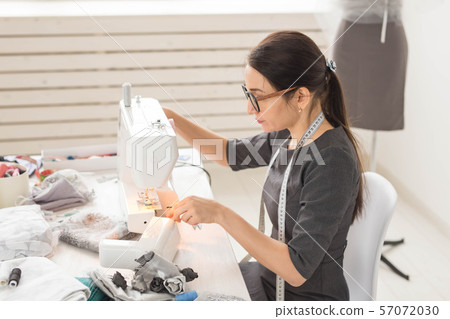 people, fashion and showroom concept - young fashion designer in her showroom people, fashion and showroom concept - young fashion designer in her showroom 57072030