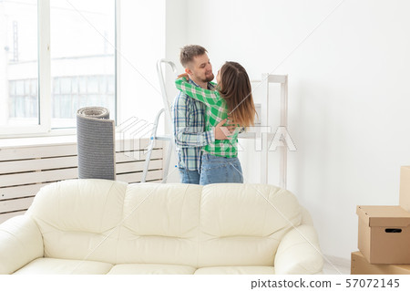 Loving young couple embracing rejoicing in moving to their new home. The concept of moving and 57072145
