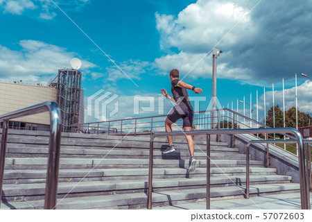 Male athlete jumping in the morning on a run, sportswear, summer fitness in the city, free space for Male athlete jumping in the morning on a run, sportswear, summer fitness in the city, free space for 57072603
