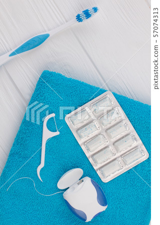 Toothbrush, dental floss, chewing gums and towel. 57074313