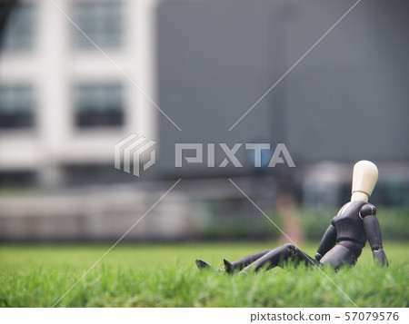 Businessman taking a break on the lawn Businessman taking a break on the lawn 57079576