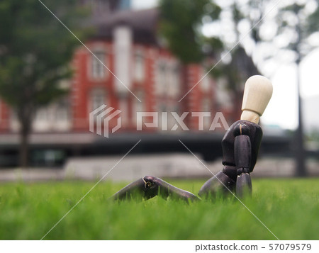 Businessman taking a break on the lawn Businessman taking a break on the lawn 57079579