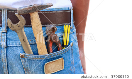Various hand tools in man's jeans back pocket. 57080550