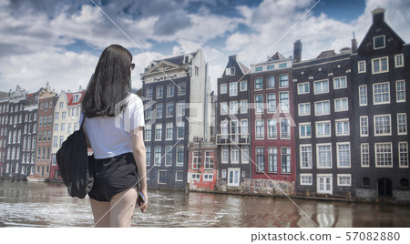 woman walks in the city of Amsterdam. woman walks in the city of Amsterdam. 57082880