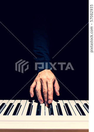 male musician hand playing on piano keys. music background male musician hand playing on piano keys. music background 57082935