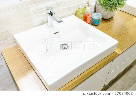 Interior of bathroom with sink basin faucet and mirror Interior of bathroom with sink basin faucet and mirror 57084008
