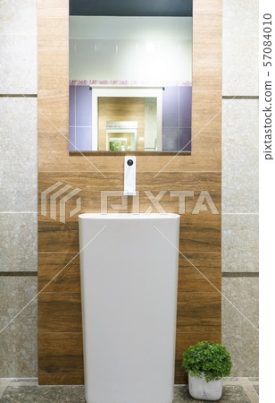 Interior of bathroom with sink basin faucet and mirror Interior of bathroom with sink basin faucet and mirror 57084010