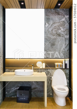 Modern spacious bathroom with bright tiles with toilet and sink. Modern spacious bathroom with bright tiles with toilet and sink. 57084012
