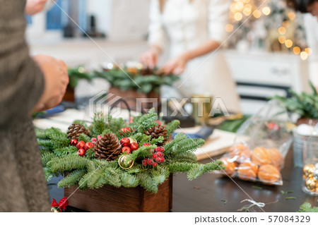 Christmas decor with their own hands. Woman created a xmas arrangement. Master class on making Christmas decor with their own hands. Woman created a xmas arrangement. Master class on making 57084329