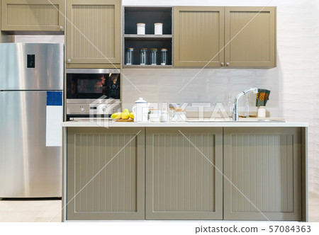 Modern, bright, clean kitchen interior with stainless steel appliances Modern, bright, clean kitchen interior with stainless steel appliances 57084363