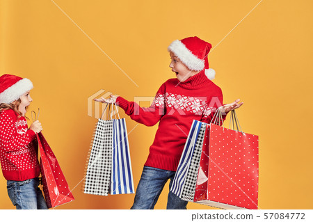 Girl giving or steals Christmas presents to shocked boy 57084772