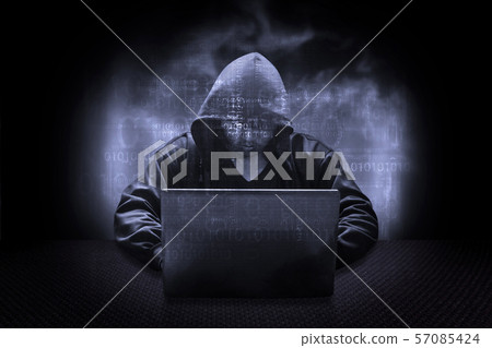 Hooded computer hacker stealing information with 57085424