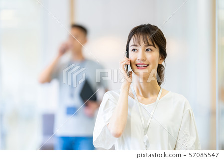 Business image of female employee talking on smartphone 57085547