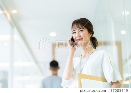 Business image of female employee talking on smartphone 57085549