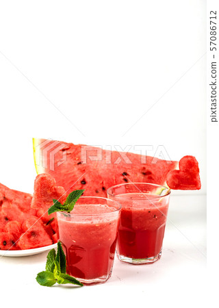 Watermelon smoothie fresh juice with mint, pieces of watermelon in the shape of hearts and slices of 57086712