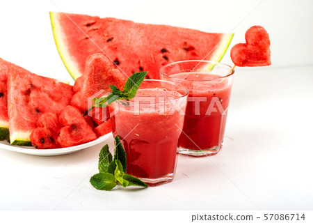 Watermelon smoothie fresh juice with mint, pieces of watermelon in the shape of hearts and slices of 57086714