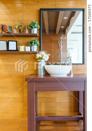 Interior of bathroom with sink basin faucet and mirror 57086975