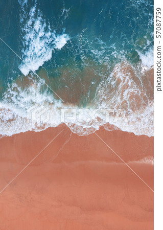 Aerial view of pink beach and blue ocean wave. 57087759