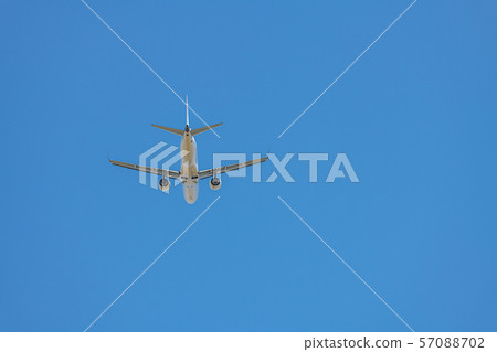 An airliner gliding over the blue sky 57088702