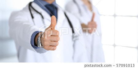 Group of doctors showing thumbs up. Perfect medical service in clinic. Happy future in medicine and Group of doctors showing thumbs up. Perfect medical service in clinic. Happy future in medicine and 57091013