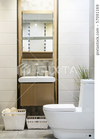 Modern spacious bathroom with bright tiles with toilet and sink. Modern spacious bathroom with bright tiles with toilet and sink. 57091169
