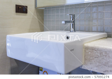Interior of bathroom with sink basin faucet and mirror Interior of bathroom with sink basin faucet and mirror 57091274