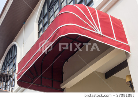 red awning over door and concrete wall background 57091895