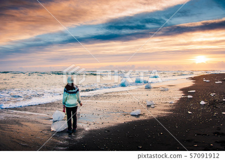 Woman enjoying Diamond beach view in Iceland Woman enjoying Diamond beach view in Iceland 57091912