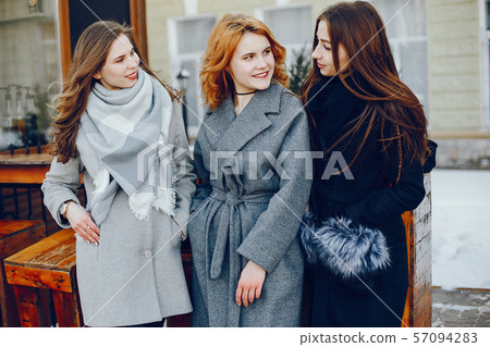 three pretty girl in a winter city 57094283