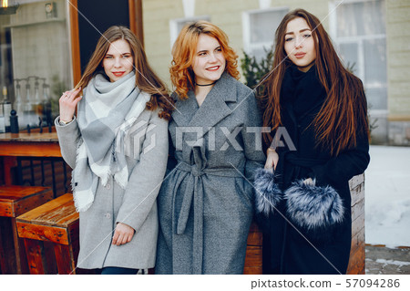 three pretty girl in a winter city 57094286