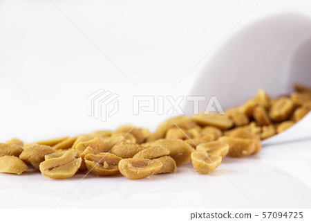 salted peanuts on white background. salted peanuts on white background. 57094725