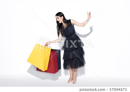 Young woman in dress shopping on white background 57094873