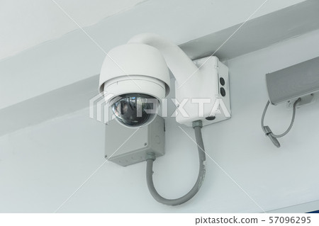 Modern CCTV camera on a wall in the airport. Modern CCTV camera on a wall in the airport. 57096295