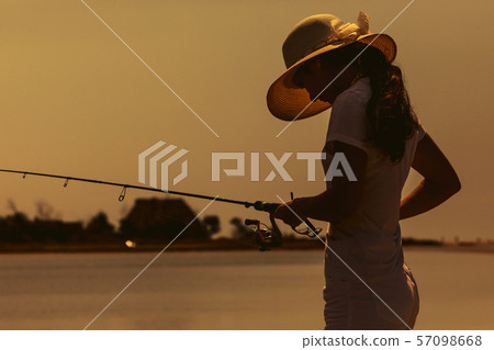 Young woman fishing at sea Young woman fishing at sea 57098668