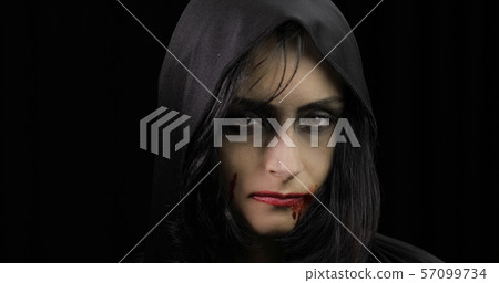 Vampire Halloween makeup. Woman portrait with blood on her face. Vampire Halloween makeup. Woman portrait with blood on her face. 57099734