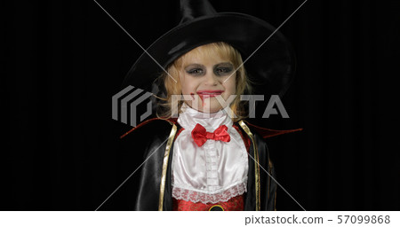 Dracula child. Girl with halloween make-up. Vampire kid with blood on her face Dracula child. Girl with halloween make-up. Vampire kid with blood on her face 57099868