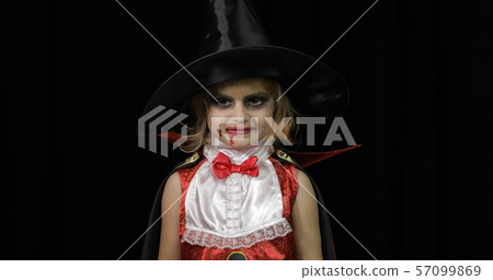 Dracula child. Girl with halloween make-up. Vampire kid with blood on her face Dracula child. Girl with halloween make-up. Vampire kid with blood on her face 57099869
