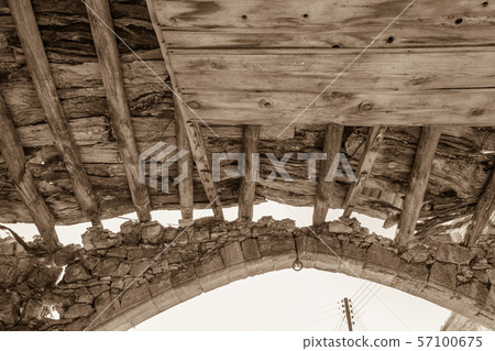 Wooden beams and stone arch of derelict building in Lofou, Cyprus Wooden beams and stone arch of derelict building in Lofou, Cyprus 57100675