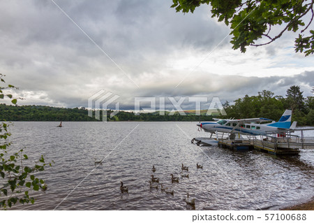 Hydroplane, ducks and dramatic cloudscape- lake shore in Loch Lomond, Cameron Bay, Scotland Hydroplane, ducks and dramatic cloudscape- lake shore in Loch Lomond, Cameron Bay, Scotland 57100688