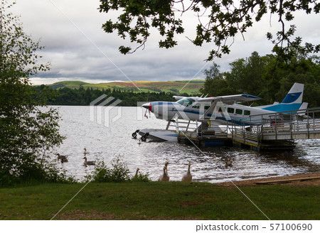 Hydroplane and ducks at lake shore in Loch Lomond, Scotland at Cameron Bay Hydroplane and ducks at lake shore in Loch Lomond, Scotland at Cameron Bay 57100690