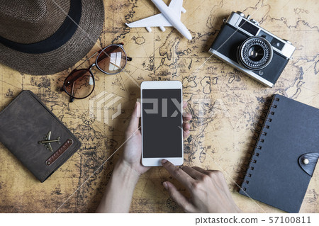 Retro camera with toy plane and smartphone on old 57100811