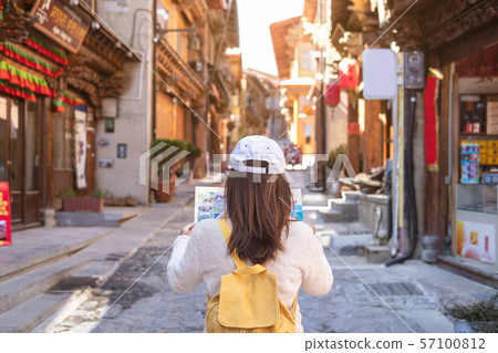 Young woman traveler walking in the old town, 57100812