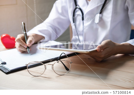 Doctor using a digital tablet in the hospital, Doctor using a digital tablet in the hospital, 57100814