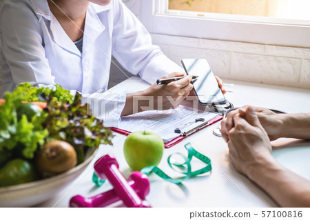 Nutritionist giving consultation to patient with Nutritionist giving consultation to patient with 57100816