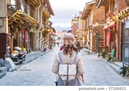 Young woman traveler walking in the old town, 57100831