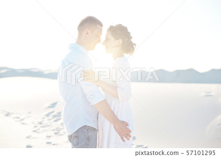 Loving couple kissing at sunset. love in the sun. Valentine's day in nature beach. Loving couple kissing at sunset. love in the sun. Valentine's day in nature beach. 57101295