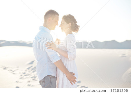 Loving couple kissing at sunset. love in the sun. Valentine's day in nature beach. Loving couple kissing at sunset. love in the sun. Valentine's day in nature beach. 57101296